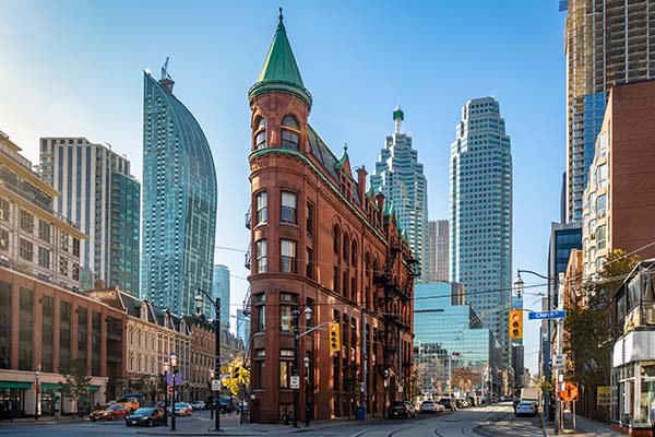 Building in downtown Toronto with CN Tower on background - Toronto, Ontario, Canada