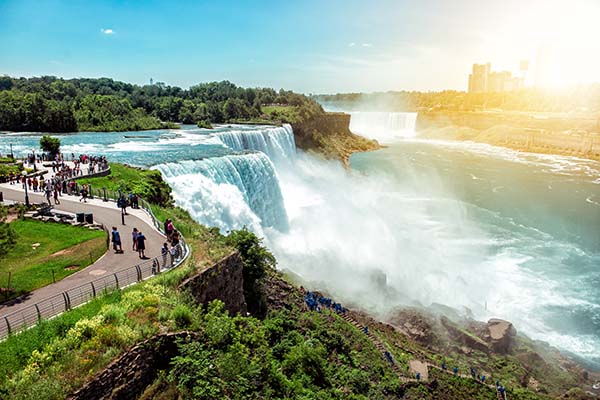 American side of Niagara falls, NY, USA. Tourists enjoying beautiful view to Niagara Falls during hot sunny summer day.