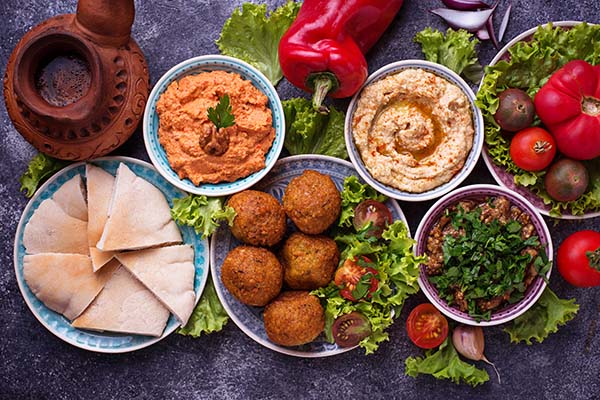 Selection of Middle eastern or Arabic dishes. Falafel, hummus, pita and  muhammara. Top view