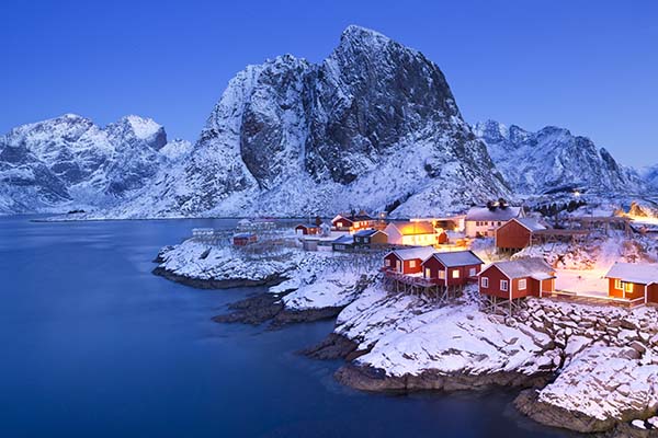 Traditional Norwegian fisherman's cabins, rorbuer, on the island of Hamnøy, Reine on the Lofoten in northern Norway. Photographed at dawn in winter.