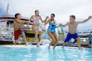 Parents-with-children-10-12-jumping-into-pool-on-cruise-ship-cm.jpg