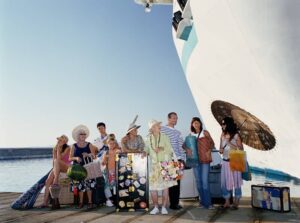 Group of people with luggage standing by ship-cm